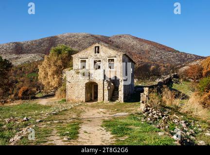 Ruined schoolhouse building in the partially abandoned village of Old Perithia (Palea Perithea) on the high slopes of Mt Pandokratoras in Corfu Greece Stock Photo