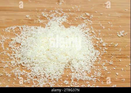 Grated Parmesan Cheese on a Cutting Board. Stock Photo