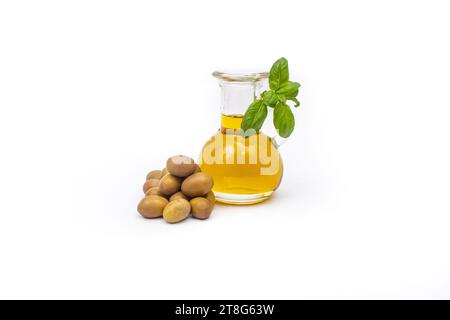 Round clear bottle full of extra virgin olive oil and green olives ...