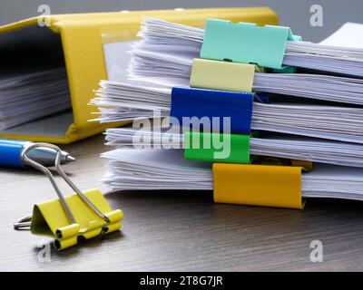 Close-up of large stack of papers with a report. Accounting and business management. Stock Photo