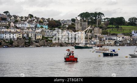 Boats are moored in the eastuary of the Fowey river, with Fowey town rising on the hillside behind, as seen from Polruan. Stock Photo