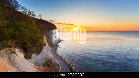 Eroded white chalk cliffs and pebble beach at sunrise in Jasmund National Park on Rugen Island in the Baltic Sea, Mecklenburg-Vorpommern, Germany Stock Photo