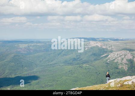 woman on the mountain nature hiking journey green forest Stock Photo