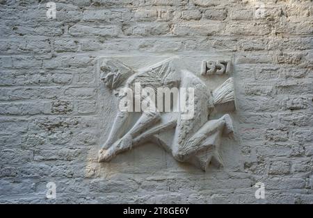 Gable stones, plaque depicting a witch on old building facade Maastricht, Costa del Sol, Netherlands Stock Photo