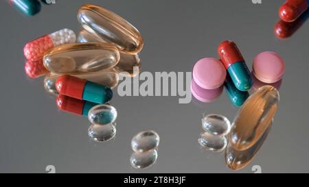 Various Medicine Pills, Tablets and Vitamins on Glass Table. Glass of water. Close up. Pharmaceuticals, medication, healthcare, treatment concept Stock Photo