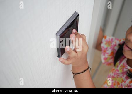 child finger turning on lighting switch with copyspace  Stock Photo