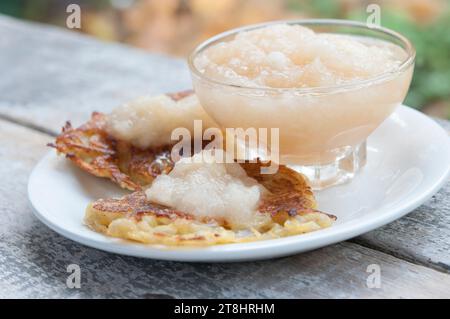 Traditional German potato pancakes with home made apple sauce. Stock Photo