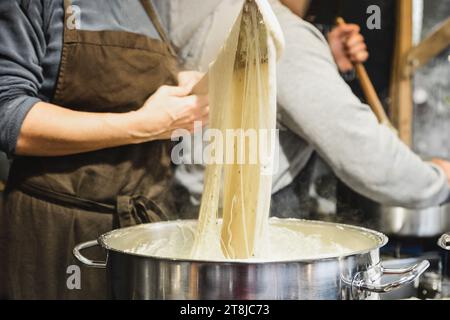Baker kneads dough on the market The dough winds on a stick Stock Photo