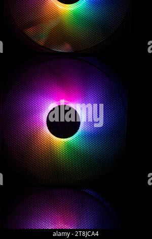 three colorful bright rainbow led rgb pc fan air case cooler white desktop  computer chassis. gaming modding water cooling and technology concept  background Stock Photo
