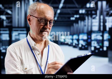 Senior engineer in crypto server farm with specialized hardware using Blockchain technology for cryptocurrency mining. Fintech expert using asic rigs to solve complex computational problems Stock Photo