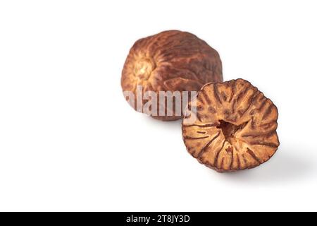 Two dried nutmegs isolated on white background Stock Photo