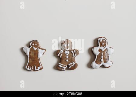 Set of ugly gingerbread cookies, hand made by kids. Smiling gingerbread man, angel isolated on white table background. Christmas traditional sweet Stock Photo