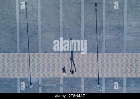 Santiago, Metropolitana, Chile. 20th Nov, 2023. The shadow of a man walking with his dog in a park in Santiago, Chile. (Credit Image: © Matias Basualdo/ZUMA Press Wire) EDITORIAL USAGE ONLY! Not for Commercial USAGE! Stock Photo