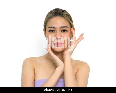 Beautiful young asian woman with clean fresh skin touch her own face . Facial treatment. Cosmetology, beauty and spa. Face care Stock Photo