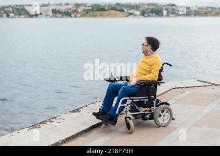 a man with disabilities near the sea Stock Photo
