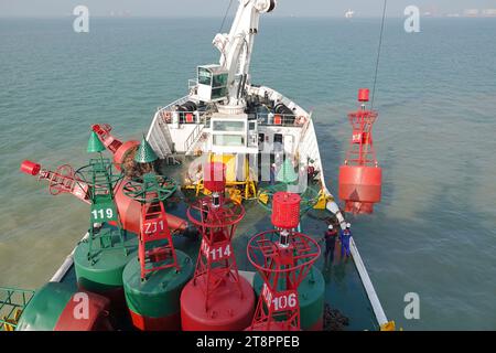 YANTAI, CHINA - NOVEMBER 21, 2023 - The 'Haixun 153' navigation vessel releases a new beacon into the sea at the main channel of Longkou Port, Shandon Stock Photo