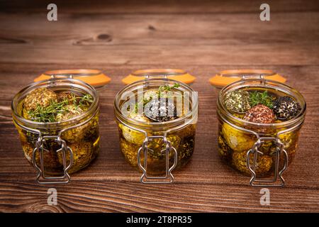 LABNEH CHEESE BOLLS WITH DRY MINT, BLACK AND WHITE SESAME, SUMAC AND ZAATAR IN A JAR WITH OLIVE OIL Stock Photo