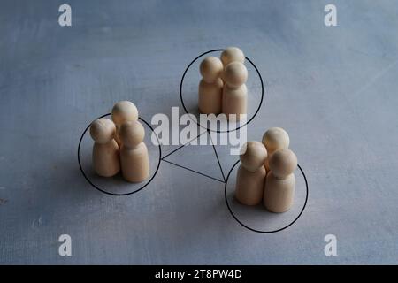 Groups of people are connected by lines. Interacting and joining forces with other teams. Interdependence correlation in workflow. Stock Photo