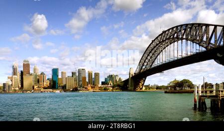 Sydney and its Bridge, Sydney, capital of New South Wales and one of Australia's largest cities, is best known for its harbourfront Opera House, with a distinctive sail-like design. Massive Darling Harbour and Circular Quay are hubs of waterside life, with the towering, arched Harbour Bridge and esteemed Royal Botanic Gardens nearby. Sydney Towers 268m glass viewing platform, the Skywalk, offers 360-degree views of the city, harbour and suburbs Stock Photo