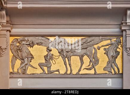 Art Nouveau low relief panel, designed by Jacek Malczewski, showing winning artist, his Pegasus, in front of the Muse, Palace of Arts in Krakow, Polan Stock Photo