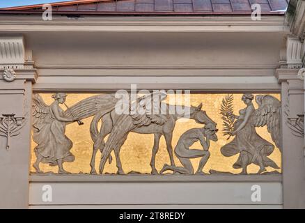 Art Nouveau low relief panel, designed by Jacek Malczewski, showing losing artist, his Pegasus, in front of the Muse, Palace of Arts in Krakow, Poland Stock Photo