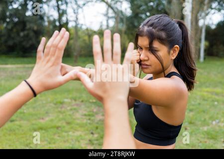 Young female boxer training outdoors. Boxing sparring and punching workout. Stock Photo