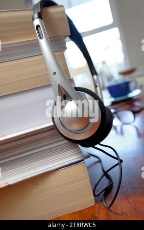 books and headphones on table top in home interior Stock Photo