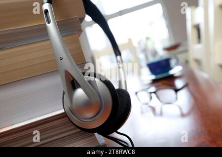 books and headphones on table top in home interior Stock Photo