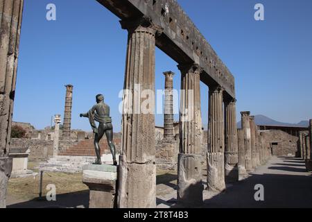 Pompeii Ruins: Temple of Apollo & Bronze Statue of Apollo, Remains of Roman city buried by eruption of Mt. Vesuvius in 79 AD and excavated in modern times, Italy Stock Photo