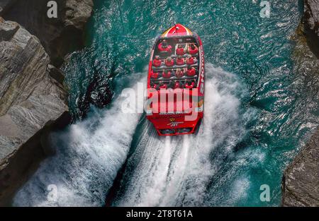 Jet Boat Ride. NZ, The jet boat was developed in the 1950s by New Zealand farmer William (Bill) Hamilton, to allow navigation of the shallow Canterbury rivers. However, enterprising New Zealanders soon realised its potential as an adventure activity Stock Photo