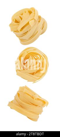 Fettuccine nests raw  falling, hanging, flying, soaring, isolated on white background. Stock Photo