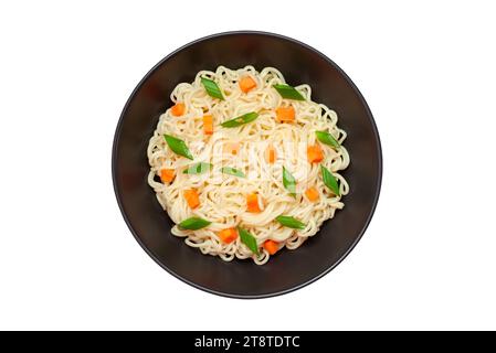 Noodles instant cooked with vegetables carrot and green onion dark bowl, top view isolated on white background with clipping path. Stock Photo