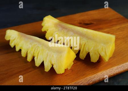 Pair of fresh ripe pineapple slices on a cutting board Stock Photo