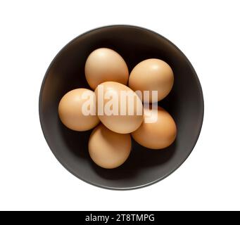 Eggs chicken whole beige in bowl, isolated on white background with clipping path. Stock Photo