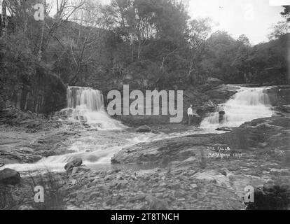 A man is standing between two rocks Stock Photo - Alamy