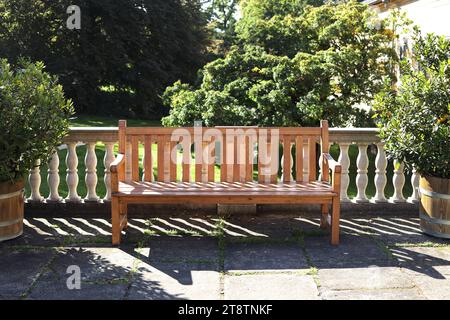 an outdoors wooden bench on the balcony Stock Photo