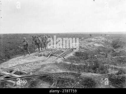 A German light railway track destroyed in France, World War I, Two New Zealand soldiers lead horses past the destroyed tracks of a light German railway near Serre, France, in World War I. Photograph taken 21 August 1918 Stock Photo