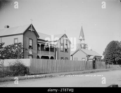 St Mary's Church and Convent, Opotiki, View of St Mary's Church and Convent. A man is standing on scaffolding erected on the church bell tower. in early 1900s Stock Photo