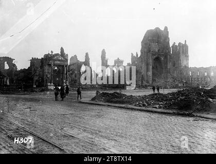 View of ruins in Ypres, Belgium, Soldiers walk among the ruins of bombed buildings in Ypres, Belgium, 1917 Stock Photo