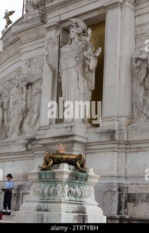 Rome - National Monument to Victor Emmanuel II. Tomb of the Unknown Soldier, under the statue of goddess Roma, with the eternal flame Stock Photo