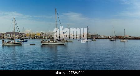 A view across from the causeway across the bay to the shoreline of Arrecife, Lanzarote on a sunny afternoon Stock Photo