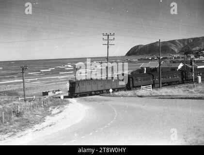 A passenger train passing through a railway crossing at Plimmerton, ca 1930s-1940s Stock Photo