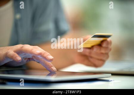 Close-up of adult woman's hands while paying with credit card online Stock Photo