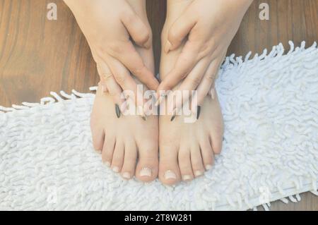 Closeup photo of a female feet and hands at spa salon on pedicure and manicure procedure Stock Photo