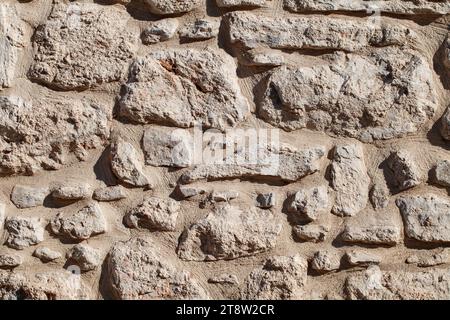 Wall old stone rock, from broken stones of irregular shape, texture for background Stock Photo