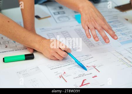 Cropped image of architects hands pointing on paper work Stock Photo