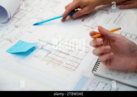 Cropped image of architects hands pointing on blueprint Stock Photo