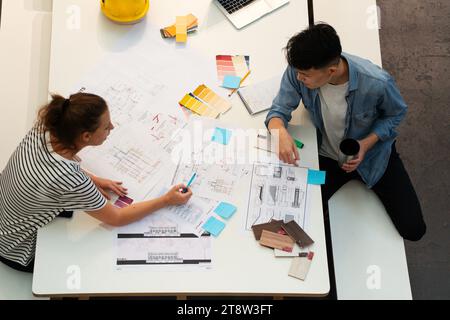 High angle view of civil engineers discussing over blueprints Stock Photo