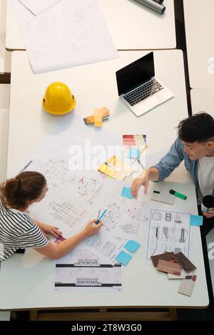 High angle view of civil engineers discussing over blueprints Stock Photo