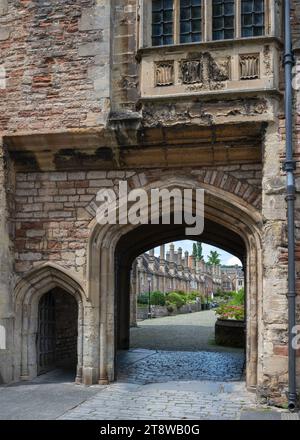 Looking through the waggon gate and archway in Vicars Hall at the entrance to Vicars close, adjacent to the cathedral in Wells, Somerset, England, UK Stock Photo